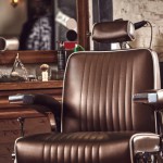 Barbershop brown armchair. Modern hairdresser and hair salon, barber shop for men.